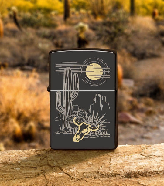 A Western two-tone design. Barren landscape laser etched onto a High Polish Black lighter, incorporating subtle touches of brass. All metal construction; windproof design works virtually anywhere. Refillable for a lifetime of use. Comes packaged in a gift box. Available in our Smyrna, TN shop.

Made in USA
Fuel: Zippo lighter fuel (sold separately)
Lighter Specs: Height: 2.25" Width: 0.5" Depth: 1.5" Weight: 2.0 oz
Lifetime guarantee that "it works or we fix it free™" Zippo contact info on gift box.