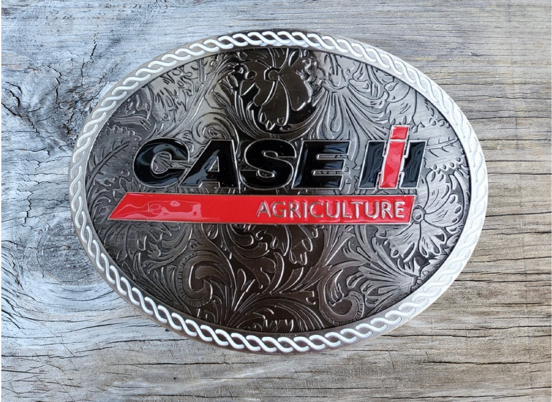 CASE Farmall IH Belt Buckle. Western Floral background oval with classic logo in Red, Black and a White rope style border. Size approx. 3 3/4" wide x 2 3/4" height, Fits up to 1 1/2" wide belts. Available in our shop in Smyrna, TN just outside Nashville.