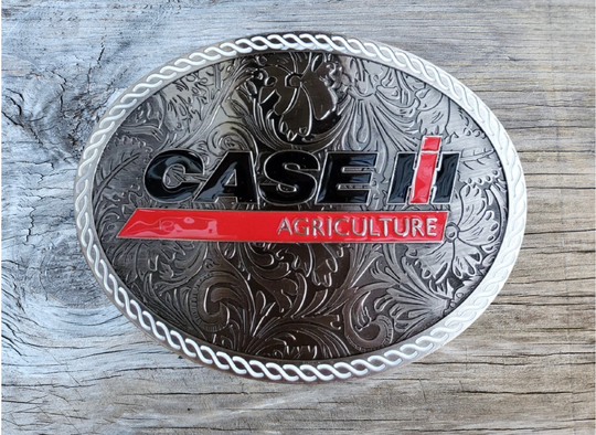 CASE Farmall IH Belt Buckle. Western Floral background oval with classic logo in Red, Black and a White rope style border. Size approx. 3 3/4" wide x 2 3/4" height, Fits up to 1 1/2" wide belts. Available in our shop in Smyrna, TN just outside Nashville.