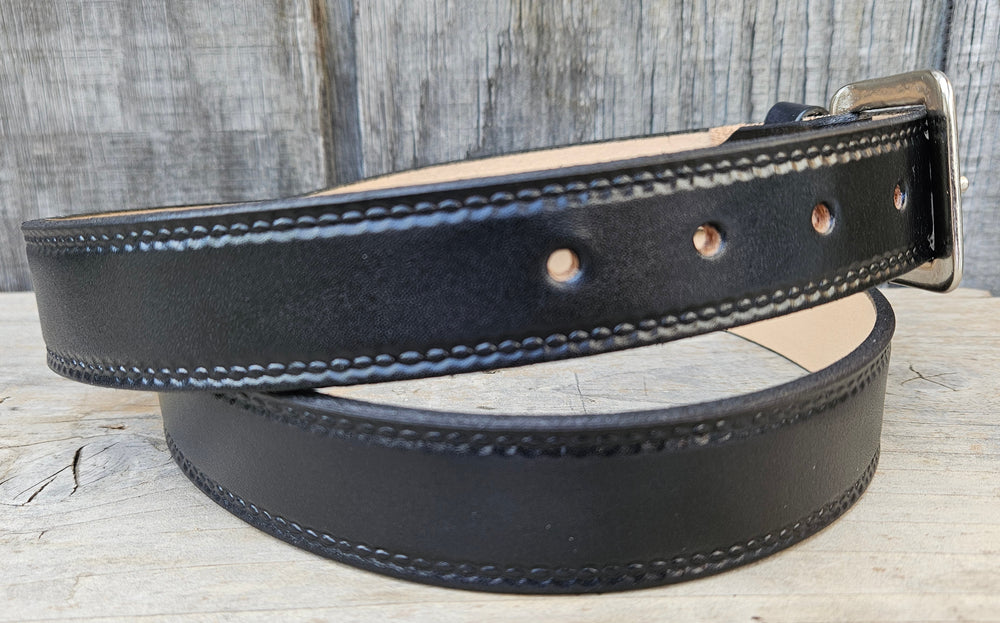 Close-up of Woodbury leather belt with embossed oval edge pattern