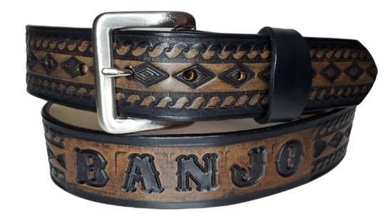 "The Banjo" is a handmade real leather belt made from a single strip of cowhide shoulder leather that is 8-10 oz. or approx. 1/8" thick. It has hand burnished (smoothed) edges and a Diamond center with a rope edge pattern. This belt is completely HAND dyed with a multi step finishing technic. The antique nickel plated solid brass buckle is snapped in place with heavy snaps.  This belt is made just outside Nashville in Smyrna, TN.