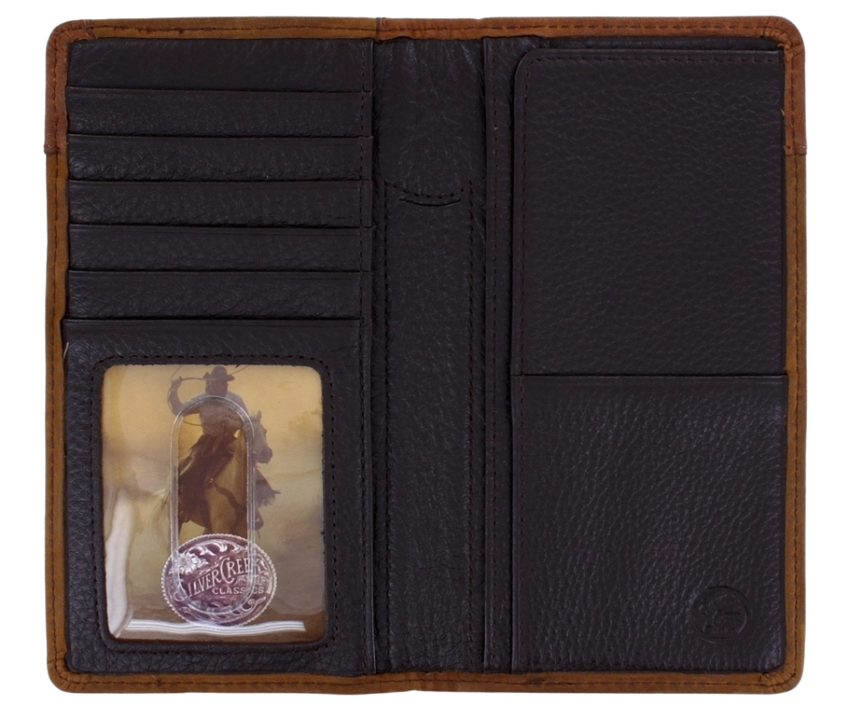 This cowboy style checkbook wallet has style that cannot be fenced in! The leather color is Aged Bark, with a barbed wire motif, the soft inside is built to fit 6 cards, checkbook, cash slot, pen, ID, and more. It's sized at 6 3/4" tall by 3 3/4" wide. Available in our Smyrna, TN store, a short drive id your in Nashville visiting. Silver Creek is Made by Brighton.