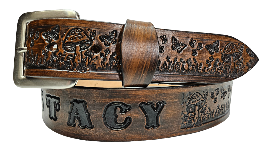 Our 1 1/2" Throwback Groovy Mushroom is a solid strip of USA veg-tan cowhide, embossed with a scene of Mushrooms, Flowers, and Butterflies down length of belt. It is hand finished in&nbsp;3 finishes, with smooth beveled, and painted edges, approx. 1/8" thick. Sizes available are&nbsp;34" to 44" from buckle end to hole most worn. Buckle is an Antique Silver finish brass, held in place with 2 snaps for easy buckle change. Crafted by hand at our Smyrna, Tennessee shop, close to Nashville.