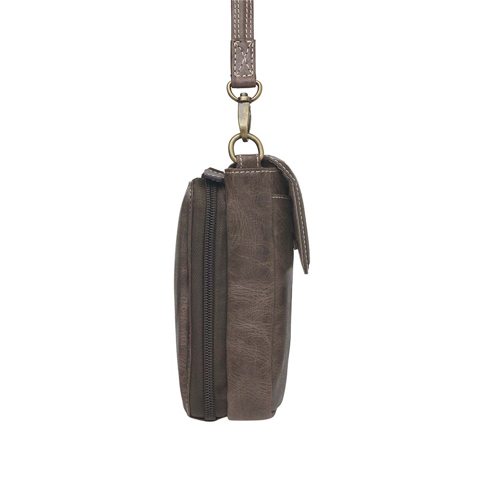 Compact Minimal Crossbody Pouch from Gun Toten' Mama is a low profile Conceal Carry purse.
Get yours at our Smyrna, TN store not far from Nashville.
The distressed brown shows a smooth oil infused Buffalo leather.
Flap closes with a magnetic closure over an open slot pocket.
Adjustable Slash Resistant Shoulder Strap clips on and off easily.
Strap length 25" to 49" long.
Overall Bag size: 5" Wide x 6-1/2" Tall x 2-1/4" Deep
Gun Compartment size: 4-3/4" Wide x 6-1/4" Tall
Gun Footprint: 4" Wide x 5" Tall