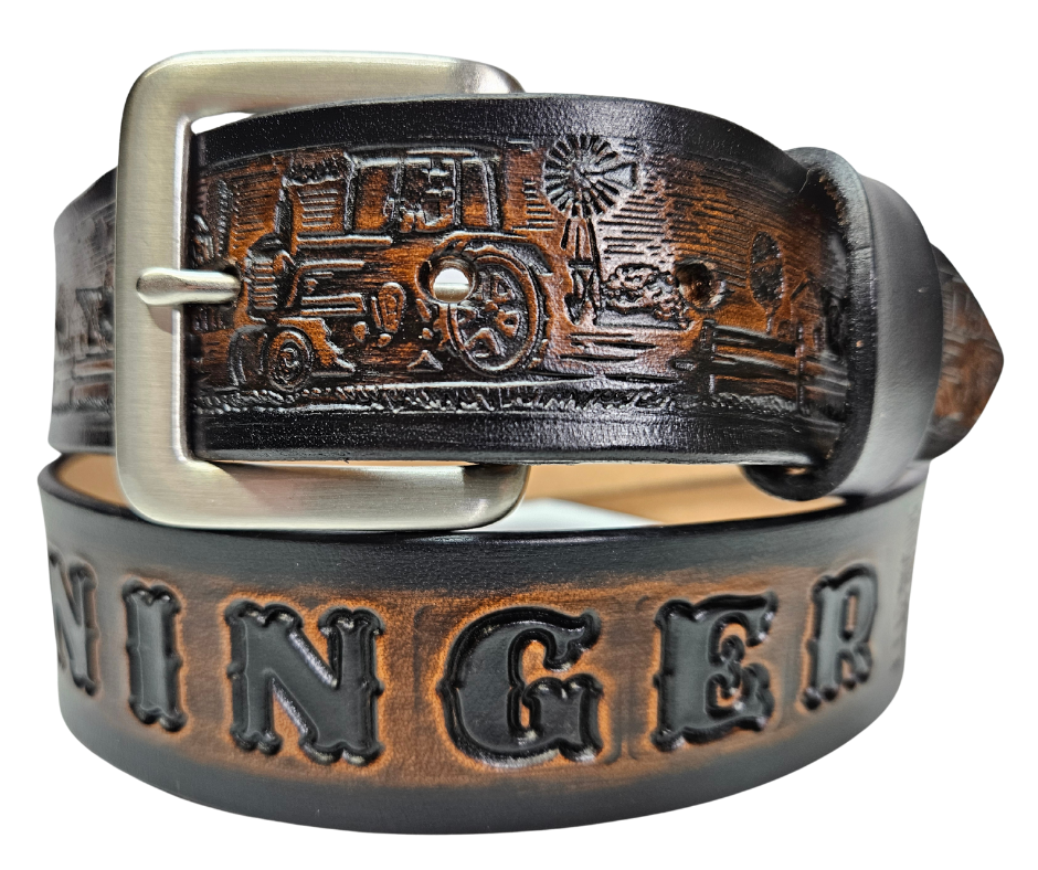 The Homestead Belt showcases the quintessential self-sustaining lifestyle through the imagery of Chickens, Tractors, Cows, and Barns. Made with 1/8" thick leather and 1 1/2" wide, the Antiqued Solid Buckle Silver is easily interchanged with two snaps. Personalize your belt with up to 10 letters. Buy yours online or come see us in Smyrna, TN, close to Nashville.
