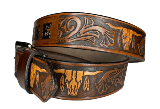 "The Longhorn" is a handmade real leather belt made from a single strip of cowhide shoulder leather that is 8-9 oz. or approx. 1/8" thick. It has smoothed edges and the Western / Longhorn scroll pattern is embossed on the surface. The antique nickel plated solid brass buckle is snapped in place.  This belt is made just outside Nashville in Smyrna, TN. 