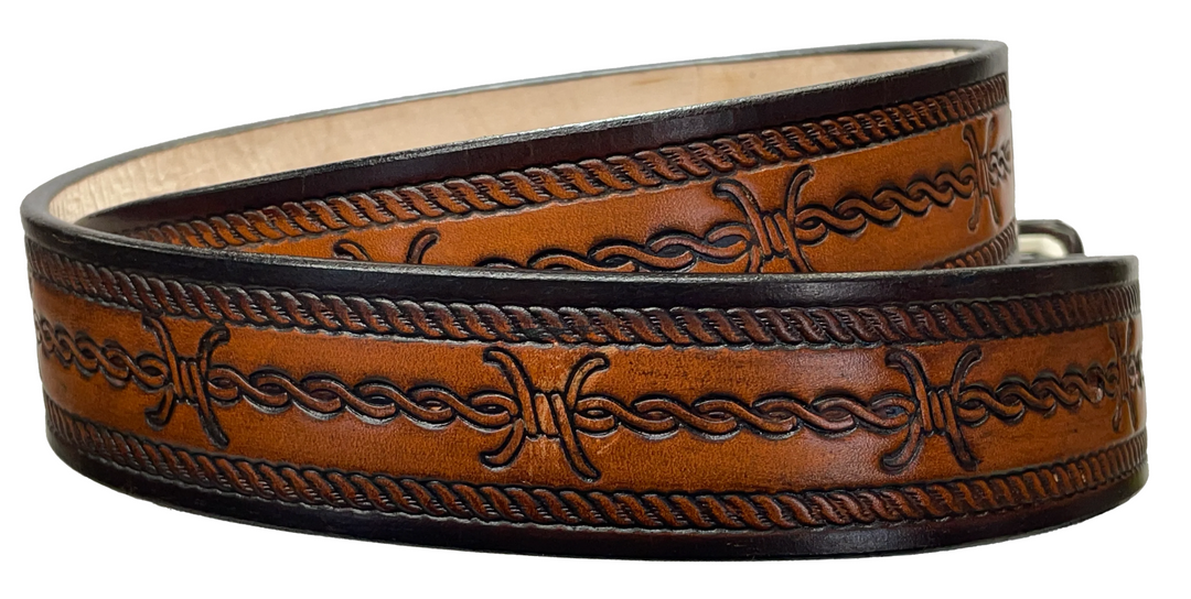 Barb Wire a western-inspired twist to any look. Made from premium veg-tan cowhide and featuring a barb wire icon design, the "Riding Fence" Name Leather Belt is the perfect way to add a touch of rustic  to your wardrobe. Hailing from our Smyrna, TN shop just outside of Nashville, TN, this belt also features an easy-to-swap buckle, so you can keep your style fresh. 