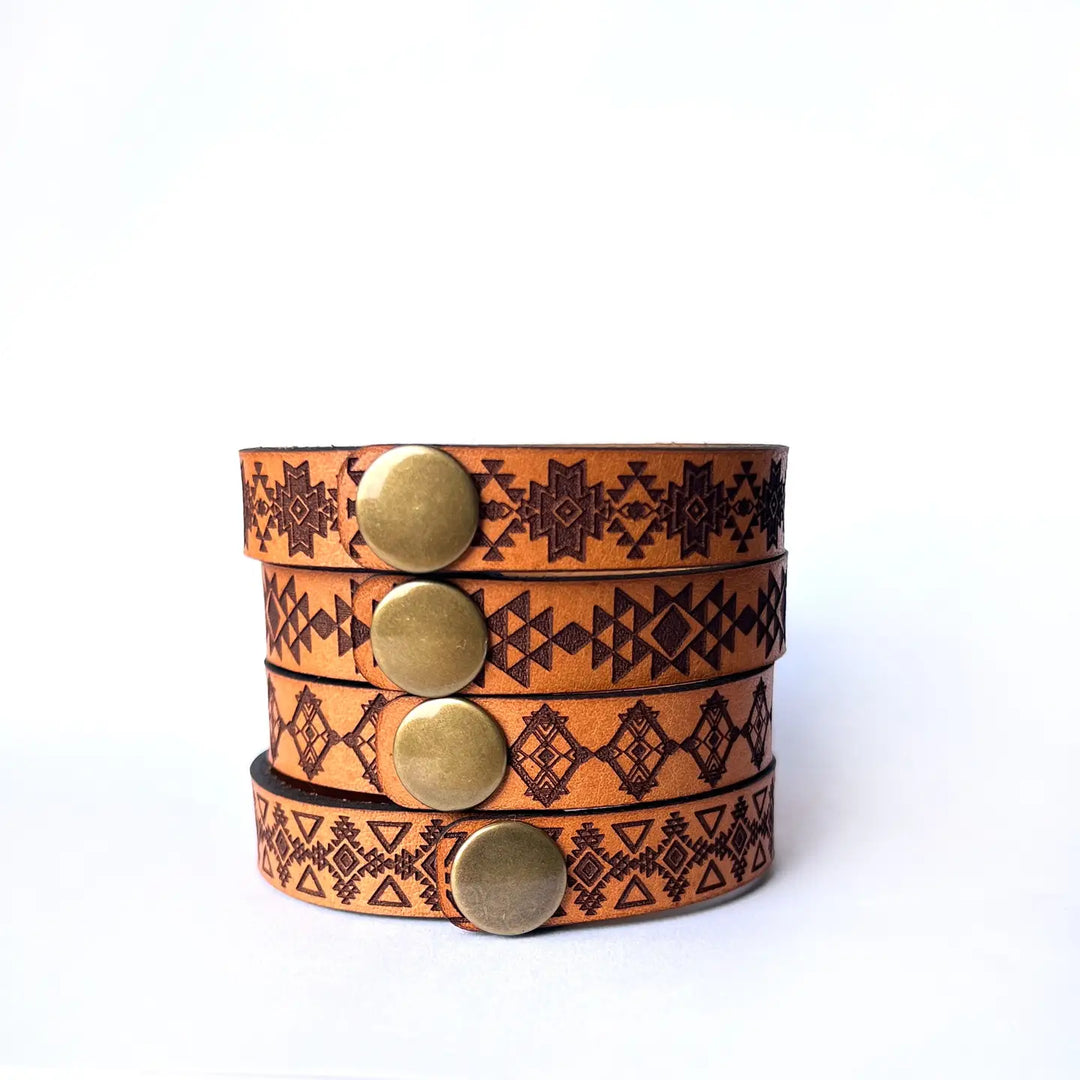Assorted Southwestern style bracelet cuffs are made from laser engraved, premium, full grain leather, and finished with solid brass snap for a long lasting touch. It's comfortable and lightweight, making it great for everyday wear. 7 1/2 x 1/2 in. Stocked at our Smyrna, TN shop. 