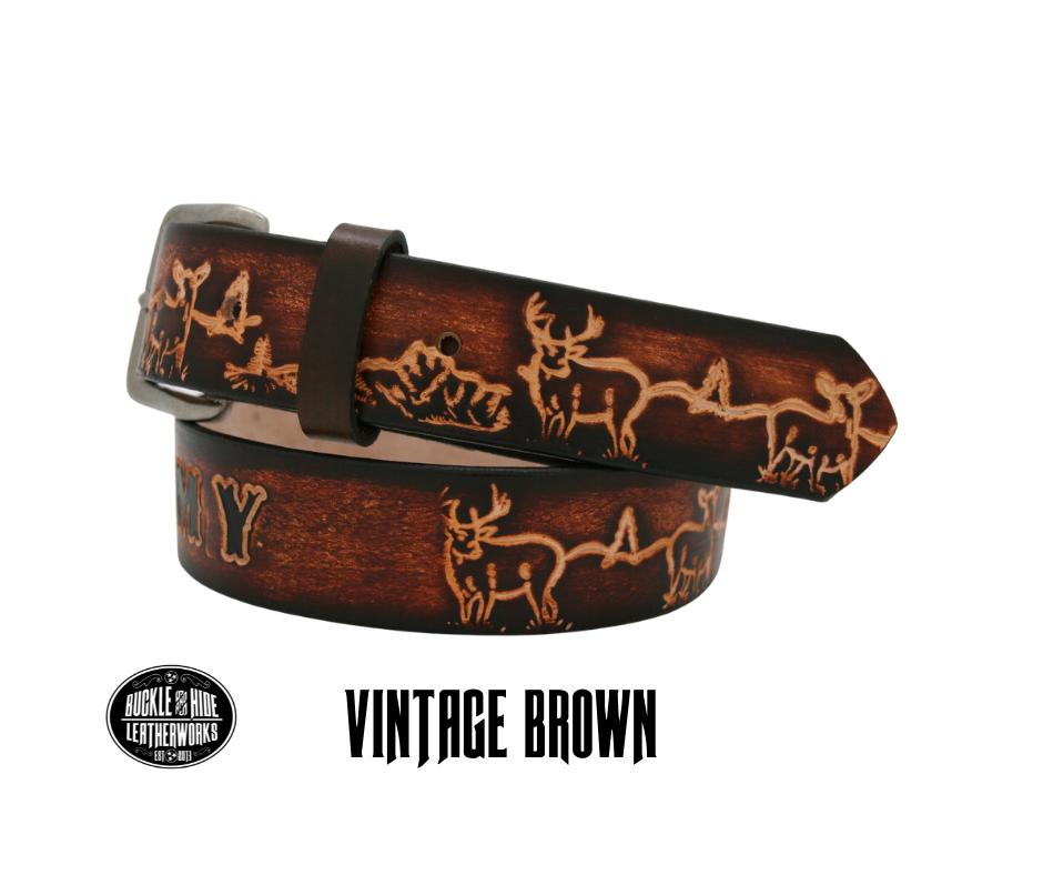 This belt is for the Outdoorsy type with Deer scene embossed onto a solid strip of Veg Tan cowhide, is hand stained brown, with smooth, finished edges. Embossed with a classic deer scene down length of belt, or have name added to scene up to 10 letters. Belt thickness is approx. 1/8", and 1 1/2" wide. Attached with 2 snaps, for easy buckle change, is an antique silver colored buckle. Made just outside Nashville in our Smyrna TN shop.