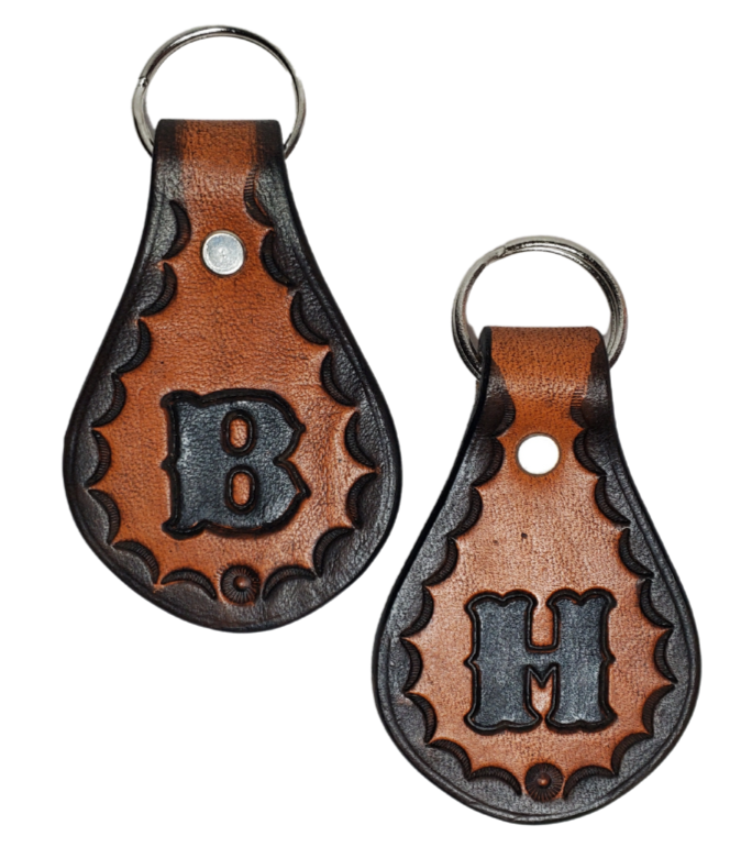 Our 1970 throwback style Leather keychain is hand stamped similar to our popular belts.  Great for identifying luggage, backpacks, or your keys! Available in the below choices All colored in our popular 2 TONE BROWN, pick one or a few, makes great gifts! Made in our Smyrna, TN shop. Please type desired initial in CUSTOM box.