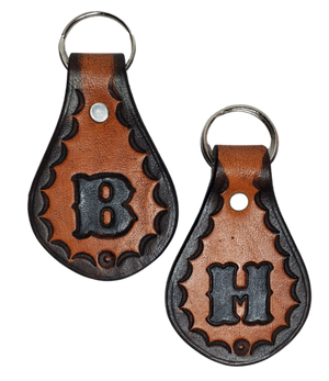 Our 1970 throwback style Leather keychain is hand stamped similar to our popular belts.  Great for identifying luggage, backpacks, or your keys! Available in the below choices All colored in our popular 2 TONE BROWN, pick one or a few, makes great gifts! Made in our Smyrna, TN shop. Please type desired initial in CUSTOM box.