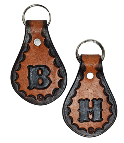 Our 1970 throwback style Leather keychain is hand stamped similar to our popular belts.  Great for identifying luggage, backpacks, or your keys! Available in the below choices All colored in our popular 2 TONE BROWN, pick one or a few, makes great gifts! Made in our Smyrna, TN shop. Please type desired initial in CUSTOM box.