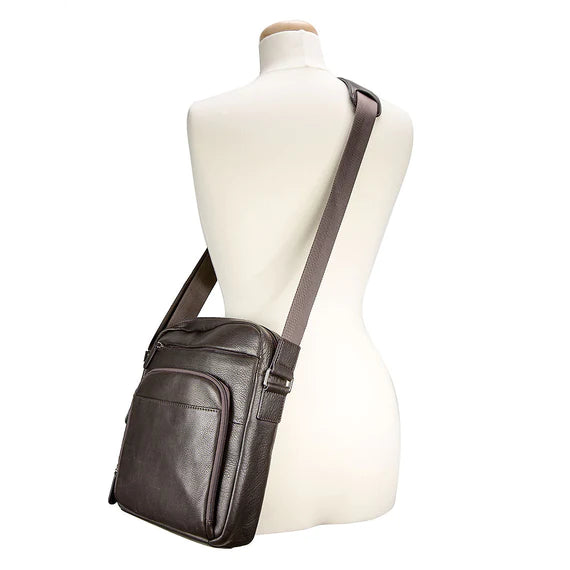 Genuine cowhide leather from Argentina. Single adjustable shoulder strap. Brushed nickel zippers. Main compartment features large open storage, zip compartment on both interior sides.  Front features deep zip compartment, ¾ zip compartment with accordion style expanding storage, two pen holders, and additional side pouch. Small magnetic snap compartment located in the front and larger magnetic snapping compartment located in rear.