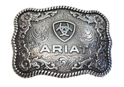 This rectangular shaped buckle has rounded edges and Ariat logo centered on surface. Surface also has scroll and flower designs and rope design around the border of the buckle. Color is antique chrome. Measures 2 1/2" tall by 3 1/2" wide.  Fits belts up to 1 1/2" wide. Available for purchase in our online store or the retail shop in Smyrna, TN, just outside Nashville. Made in Taiwan.