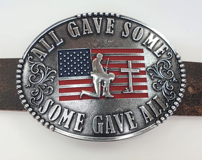 All Gave Some Some Gave All Buckle oval plate style belt buckle with American Flag inlay under kneeling soldier and cross. All Gave Some, Some Gave All imprinted around edges of buckle and scroll design on either side of wording. Available in our shop just outside Nashville in Smyrna, TN as well as on this website.  Made by AndWest in Mexico. Dimensions are 3 1/4" by 4 1/4", pictured on crackle finish brown leather belt.