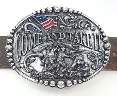 Come and Take It motif buckle by AndWest has Come and Take It wording and pictures soldiers raising and American Flag. Decorative scrolling and designs around edges. Dimensions are 3 2/4" tall by 4 1/4" wide Made in Mexico Available in our online shop as well as in the retail shop in Smyrna, TN, just outside Nashville. Pictured on belt.