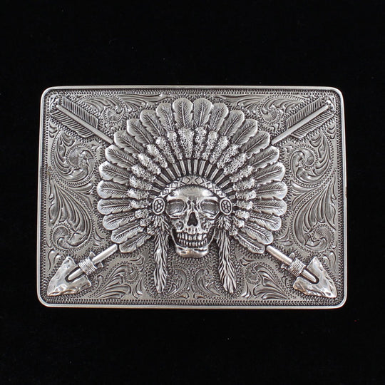 Ariat Indian Chief belt buckle Rectangle shaped buckle with a stylish smooth edge. It features a centered Indian chief skull with headdress and crossing arrows motif surrounded by western scroll engraving. Antiqued Chrome color. Measures 3-1/2" wide x 2-1/2" tall Fits belts up to 1 1/2" wide Available online or in our shop in Smyrna, TN just outside Nashville. Alternate view.