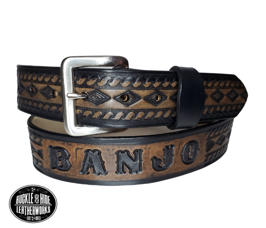 "The Banjo" is a handmade real leather belt made from a single strip of cowhide shoulder leather that is 8-10 oz. or approx. 1/8" thick. It has hand burnished (smoothed) edges and a Diamond center with a rope edge pattern. This belt is completely HAND dyed with a multi step finishing technic. The antique nickel plated solid brass buckle is snapped in place with heavy snaps.  This belt is made just outside Nashville in Smyrna, TN.