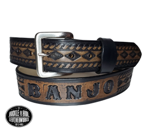 "The Banjo" is a handmade real leather belt made from a single strip of cowhide shoulder leather that is 8-10 oz. or approx. 1/8" thick. It has hand burnished (smoothed) edges and a Diamond center with a rope edge pattern. This belt is completely HAND dyed with a multi step finishing technic. The antique nickel plated solid brass buckle is snapped in place with heavy snaps.  This belt is made just outside Nashville in Smyrna, TN.