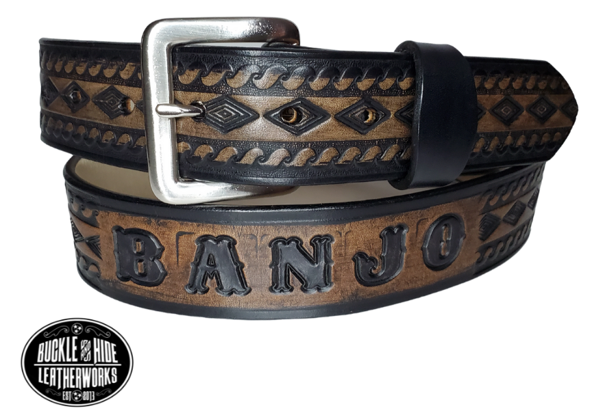 "The Banjo" is a handmade real leather belt made from a single strip of cowhide shoulder leather that is 8-10 oz. or approx. 1/8" thick. It has hand burnished (smoothed) edges and a Diamond center with a rope edge pattern. This belt is completely HAND dyed with a multi step finishing technic. The antique nickel plated solid brass buckle is snapped in place with heavy snaps.  This belt is made just outside Nashville in Smyrna, TN.