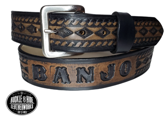 "The Banjo" is a handmade real leather belt made from a single strip of cowhide shoulder leather that is 8-10 oz. or approx. 1/8" thick. It has hand burnished (smoothed) edges and a Diamond center with a rope edge pattern. This belt is completely HAND dyed with a multi step finishing technic. The antique nickel plated solid brass buckle is snapped in place with heavy snaps.  This belt is made just outside Nashville in Smyrna, TN.
