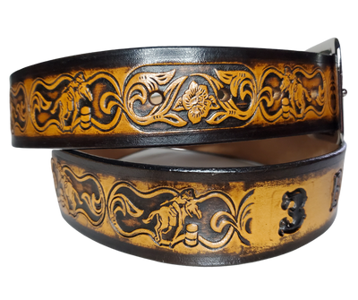 "The Barrel Racer" is a handmade real leather belt made from a single strip of cowhide shoulder leather that is 8-10 oz. or approx. 1/8" thick. It has hand burnished (smoothed) edges and a western influenced Rodeo events pattern. This belt is completely HAND dyed with a multi step finishing technic. The antique nickel plated solid brass buckle is snapped in place with heavy snaps.  This belt is made just outside Nashville in Smyrna, TN.