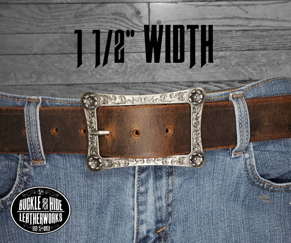 This rustic leather belt is made from Crazy Horse tanned leather for that distressed and used look. The edges are beveled and burnished leaving the natural color for a contrasting appearance. It has a Center Bar style buckle with a Western influenced scroll pattern. Buckle is antique nickel plated and snaps in place, for an easy buckle change giving it a totally different look. Belt is 1 1/2" wide and available in lengths from 32" to 44".  It is handmade in our shop in Smyrna, TN, just outside of Nashville.