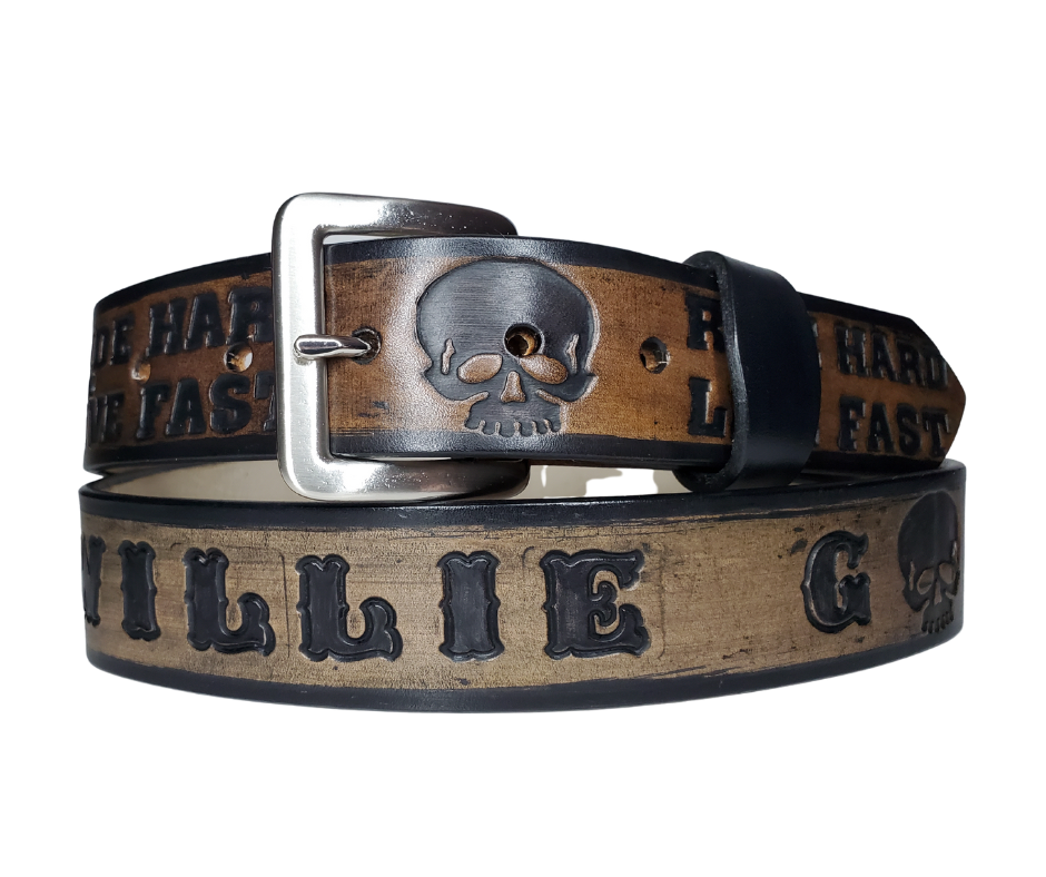 "The Daytona" is a handmade real leather belt made from a single strip of cowhide shoulder leather that is 8-10 oz. or approx. 1/8" thick. It has hand burnished (smoothed) edges and features the mantra "RIDE HARD LIVE FAST" and an HD Skull pattern down the center. This belt is completely HAND dyed with a multi step finishing technic. The antique nickel plated solid brass buckle is snapped in place with heavy snaps.  This belt is made just outside Nashville in Smyrna, TN.