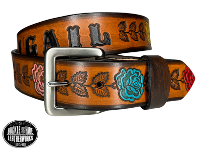 "The Heirloom Rose" is a handmade real leather belt made from a single strip of cowhide shoulder leather that is 8-10 oz. or approx. 1/8" thick. It has hand burnished (smoothed) edges and summer flowers embossed on the surface and with most HAND PAINTED in Pink, White, Yellow, Red and Turquoise. The antique nickel plated solid brass buckle is snapped in place with heavy snaps.  This belt is made just outside Nashville in Smyrna, TN.