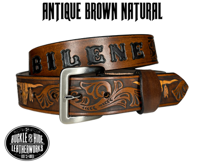 "The Longhorn"is a handmade real leather belt made from a single strip of cowhide shoulder leather that is 8-9 oz. or approx. 1/8" thick. It has smoothed edges and the Western / Longhorn scroll pattern is embossed on the surface. The antique nickel plated solid brass buckle is snapped in place.  This belt is made just outside Nashville in Smyrna, TN. 