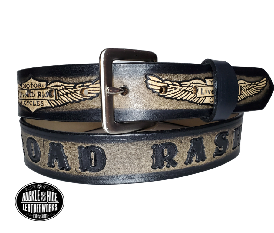 "The SGT AT Arms" is a handmade real leather belt made from a single strip of cowhide shoulder leather that is 8-10 oz. or approx. 1/8" thick. It has hand burnished (smoothed) edges and the Classic Wings and Shield pattern down the center. This belt is completely HAND dyed with a multi step finishing technic. The antique nickel plated solid brass buckle is snapped in place with heavy snaps.  This belt is made just outside Nashville in Smyrna, TN.