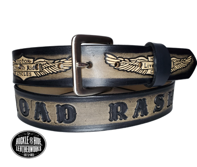 "The SGT AT Arms" is a handmade real leather belt made from a single strip of cowhide shoulder leather that is 8-10 oz. or approx. 1/8" thick. It has hand burnished (smoothed) edges and the Classic Wings and Shield pattern down the center. This belt is completely HAND dyed with a multi step finishing technic. The antique nickel plated solid brass buckle is snapped in place with heavy snaps.  This belt is made just outside Nashville in Smyrna, TN.