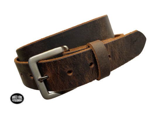 This brown leather belt is made from Crazy Horse tanned leather for that distressed and pull-up look. The edges are beveled and left raw for a contrasting look. It has an antique nickel coated solid brass buckle that is snapped in place. Belt is 1 1/2" wide and available in lengths from 34" to 44".  It is handmade in our shop in Smyrna, TN, just outside of Nashville. Choose Plain or Embossed Stitch pattern.