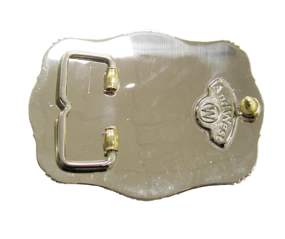 The Chief Longhorn buckle  These buckles are made from German Silver (nickel and brass alloy) or iron metal base. Some buckles have motifs made of copper, iron or brass and some are adorned with synthetic stones. These are all handcrafted. Each piece is punched, cut, soldered, engraved, polished and painted by our talented metal workers.  Available in our Smyrna TN shop. Width 4.5” Height 3”
Fits Standard 1.5” belts