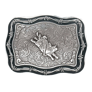 Embodying the spirit of the world's most dangerous bull, this rectangular buckle features Barbwire edges, a Western scroll design background, and a bold Bullrider. With dimensions of approximately 3" by 4", it can easily accommodate belts up to 1 1/2" wide. Find it in our retail shop in Smyrna, TN, just outside of Nashville, or in our online store.&nbsp;