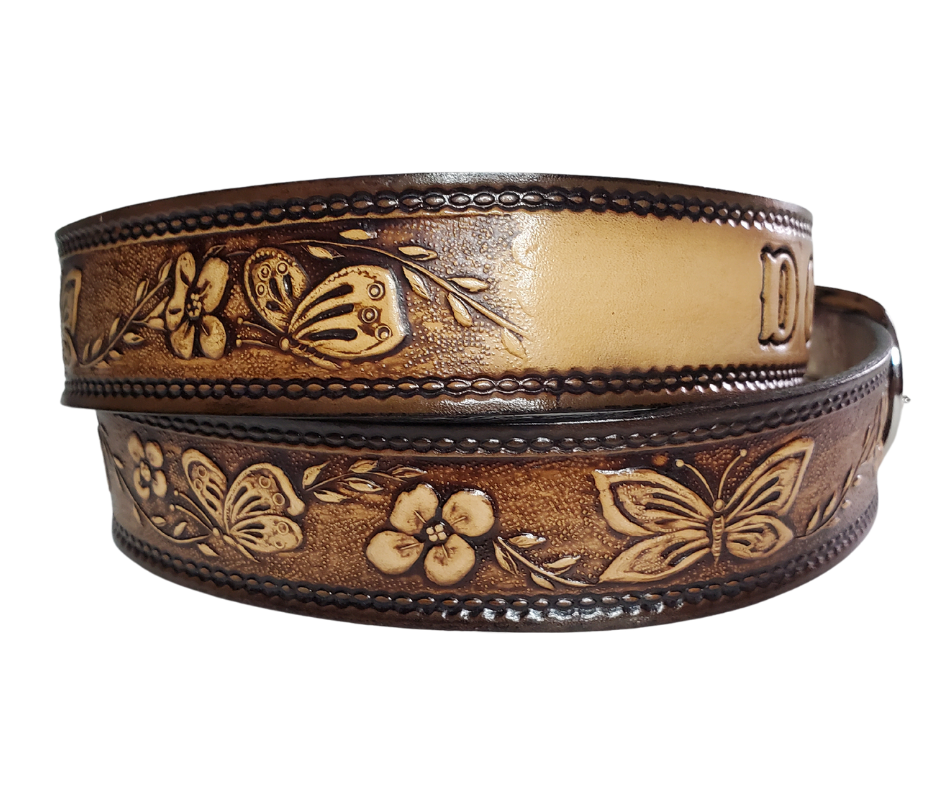 This stylish leather belt features beautiful flowers and butterfly artwork that is sure to draw attention. The easy-change metal buckle makes for comfortable wear and makes it easy to adjust for size. Perfect for adding a unique touch to any wardrobe. This belt is stocked in our shop outside Nashville in Smyrna, TN.