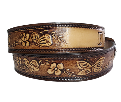 This stylish leather belt features beautiful flowers and butterfly artwork that is sure to draw attention. The easy-change metal buckle makes for comfortable wear and makes it easy to adjust for size. Perfect for adding a unique touch to any wardrobe. This belt is stocked in our shop outside Nashville in Smyrna, TN.