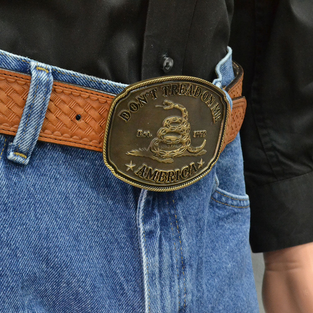 Deeply antiqued brass colored rectangular Attitude buckle with historical Gadsden saying and snake on front. Standard 1.5 belt swivel.