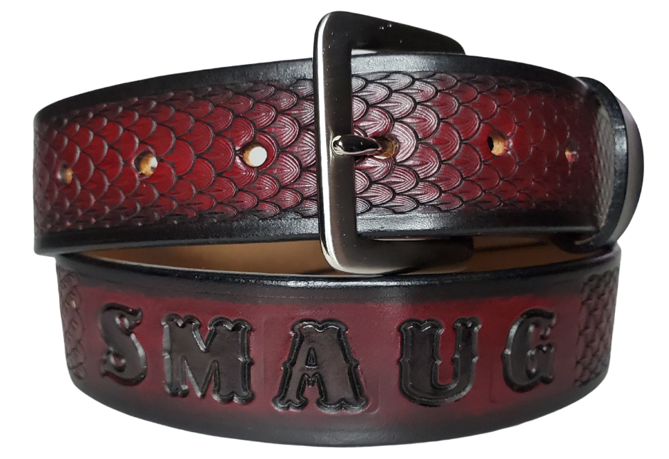 "The Dragon" will take you to the Tolkien fantasy lands with Balrog, Swords, and of course Dragons. This handmade real leather belt made from a single strip of cowhide shoulder leather that is 8-10 oz. or approx. 1/8" thick. It has hand burnished (smoothed) edges and a Dragon Scale pattern. This belt is completely HAND dyed with a multi step finishing technic. The antique nickel plated solid brass buckle is snapped in place with heavy snaps.  This belt is made just outside Nashville in Smyrna, TN.