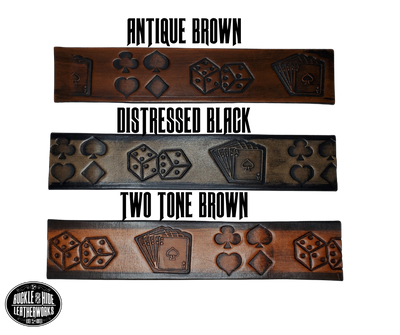 "The Gambler" is a handmade real leather belt made from a single strip of cowhide shoulder leather that is 8-10 oz. or approx. 1/8" thick. It has hand burnished (smoothed) edges and Aces, Eights, Dice, Clubs, Diamonds, Spade pattern down the center. This belt is completely HAND dyed with a multi step finishing technic. The antique nickel plated solid brass buckle is snapped in place with heavy snaps.  This belt is made just outside Nashville in Smyrna, TN.