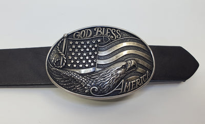 A patriotic antique silver colored, oval Nocona buckle  Intricately detailed flag and eagle head design    Dimensions 2 1/8" tall by 4" wide  Available online and in our shop in Smyrna, TN, just outside of Nashville 