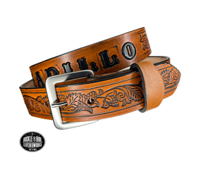 This solid strip of Veg Tan cowhide, is hand stained in 3 brown options, with smooth, finished edges. Embossed with Western Vine down length of belt, or have name added to scene up to 8 letters. Belt thickness is approx. 1/8", and 1 1/2" wide. Sizes available are 34" to 44" from buckle end to hole most worn. Attached with 2 snaps is a Brushed Nickel plated solid brass buckle. 