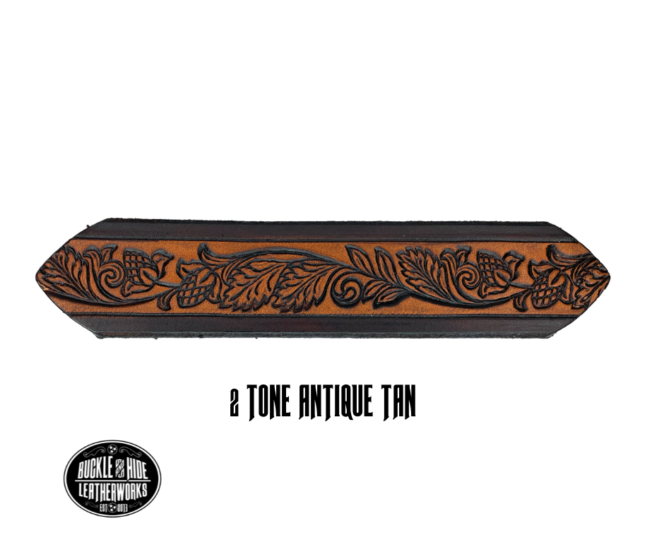 This solid strip of Veg Tan cowhide, is hand stained in 3 brown options, with smooth, finished edges. Embossed with Western Vine down length of belt, or have name added to scene up to 8 letters. Belt thickness is approx. 1/8", and 1 1/2" wide. Sizes available are 34" to 44" from buckle end to hole most worn. Attached with 2 snaps is a Brushed Nickel plated solid brass buckle. 