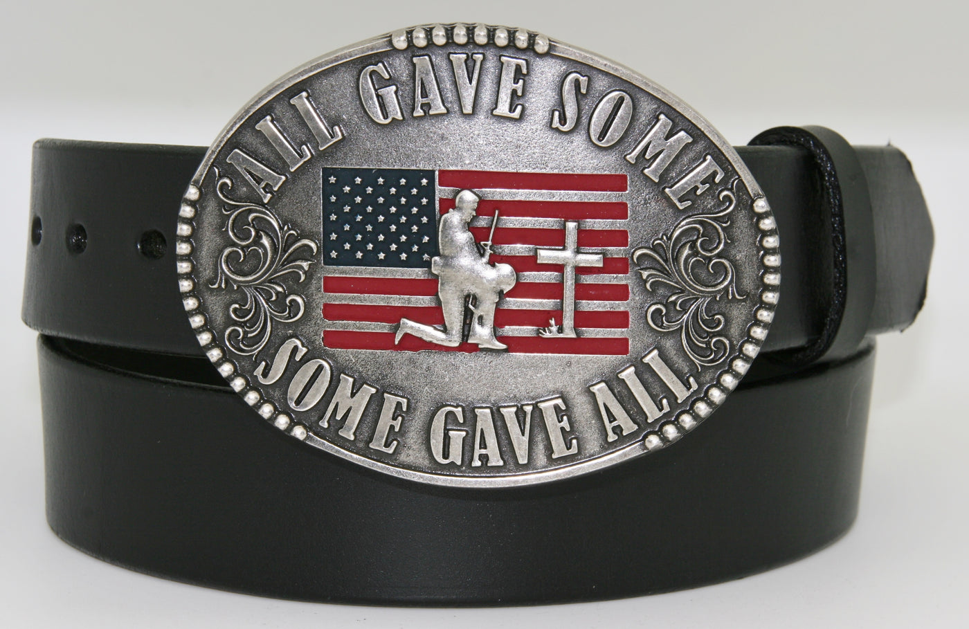 All Gave Some Some Gave All Buckle oval plate style belt buckle with American Flag inlay under kneeling soldier and cross. All Gave Some, Some Gave All imprinted around edges of buckle and scroll design on either side of wording. Available in our shop just outside Nashville in Smyrna, TN as well as on this website.  Made by AndWest in Mexico. Dimensions are 3 1/4" by 4 1/4", pictured on sturdy black leather belt, also available from this shop.