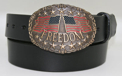 Freedom belt buckle pictured on black belt-This Freedom belt buckle by And West features 2 American Flags, one flying left and the other toward the right.  Freedom is printed across bottom of buckle and raised stars are featured along the top and bottom of this oval shaped buckle. Barbed wire design surrounds border of buckle. Color is Antique brass look with red and blue flag colors. Available in our online shop and in the retail shop in Smyrna,TN, just outside Nashville. Measures 3" tall by 4" wide. 