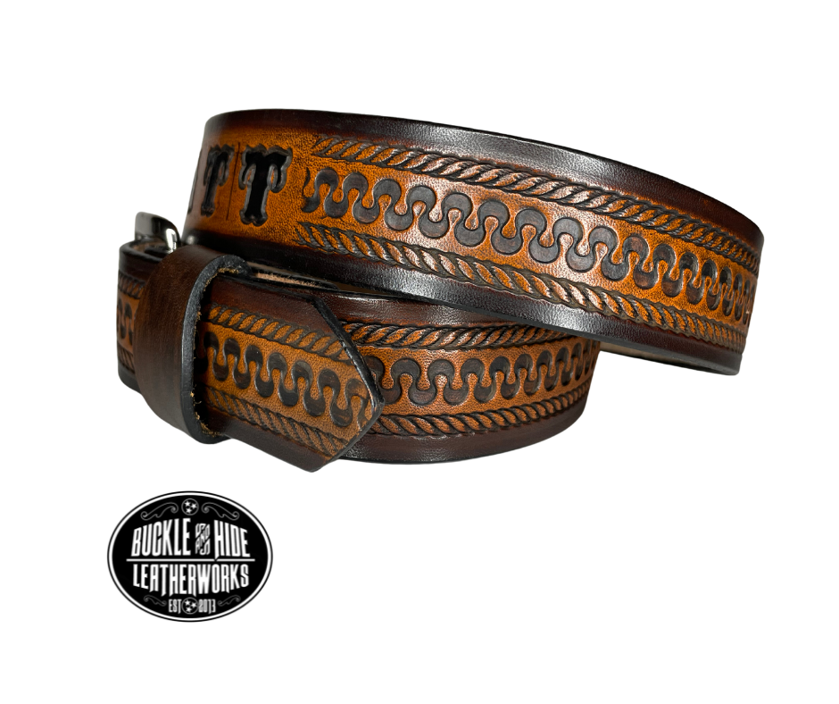 This belt's got some class! Embossed with a classic western serpentine/rope pattern and made with 1/8" thick Veg tan cowhide, the "Law Dawg" Name Leather Belt will give you the durability and style to last for miles and miles if you get a bit rowdy - It's made in our Smyrna, TN shop just outside Nashville, TN. Saddle up!