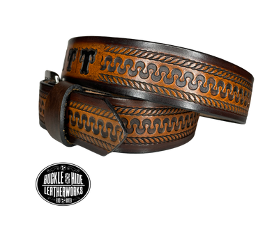 This belt's got some class! Embossed with a classic western serpentine/rope pattern and made with 1/8" thick Veg tan cowhide, the "Law Dawg" Name Leather Belt will give you the durability and style to last for miles and miles if you get a bit rowdy - It's made in our Smyrna, TN shop just outside Nashville, TN. Saddle up!