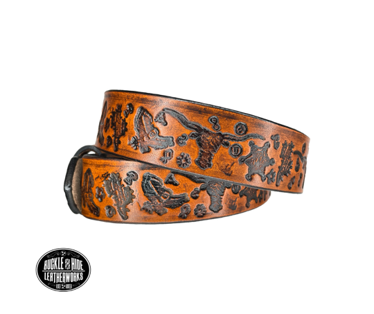 Full grain American vegetable tanned cowhide approx. 1/8"thick. Width 1 1/4" and includes Antique Nickle plated Solid Brass buckle Hand Finished Smooth burnished painted edges Choose with or without name, if without name, design will cover entire length of belt For name Type name desired on belt in "Type Name Here" section, no more than 8 letters maximum Buckle snaps in place for easy changing if desired Made in our Smyrna, TN, USA shop.