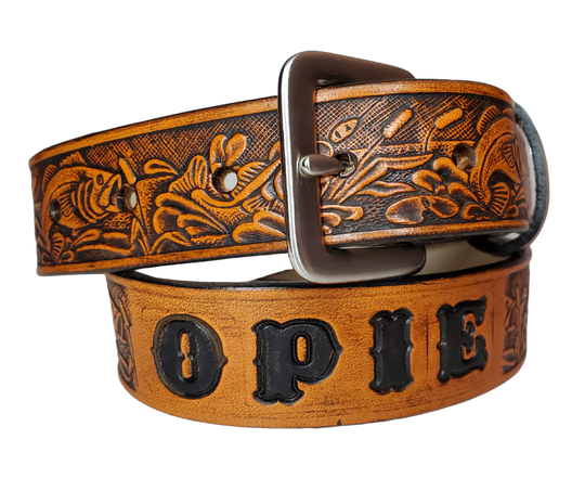 Our Lil Fishin' is just like the Fishin' for dad or mom. Full grain American vegetable tanned cowhide approx. 1/8"thick. Width is 1 1/4" and includes Antique Nickle plated Solid Brass buckle. We Hand Finish with a tan center. Edges are smooth burnished painted edges. Made in our Smyrna, TN, USA shop. Buckle snaps in place for easy changing if desired.  Choose with or without name, 