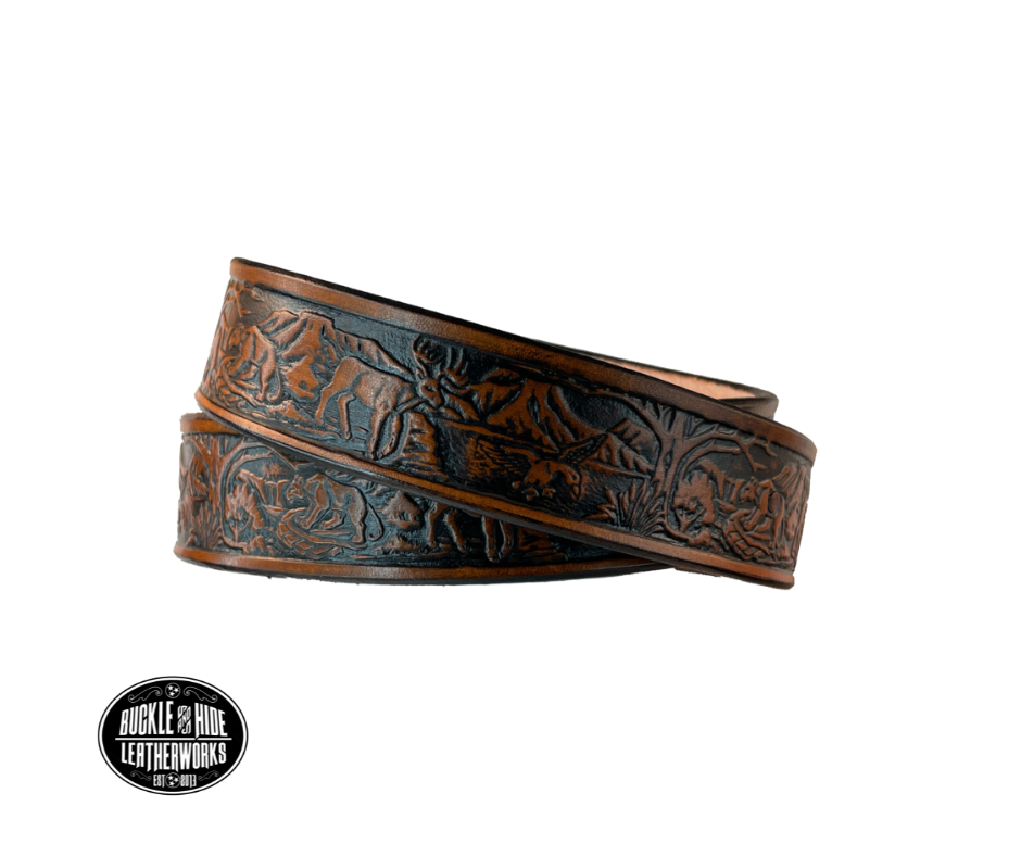 Perfect for the LIL Outdoors type the Wilderness scene embossed on veg tanned cowhide belt, about 1/8" thick, 1 1/4" width, burnished painted edges. The buckle easily snaps into place, allowing for easy changing when desired. Handcrafted with care in our Smyrna, TN shop, our Lil' Wilderness belt guarantees satisfaction. Follow our belt sizing instructions for a perfect fit    